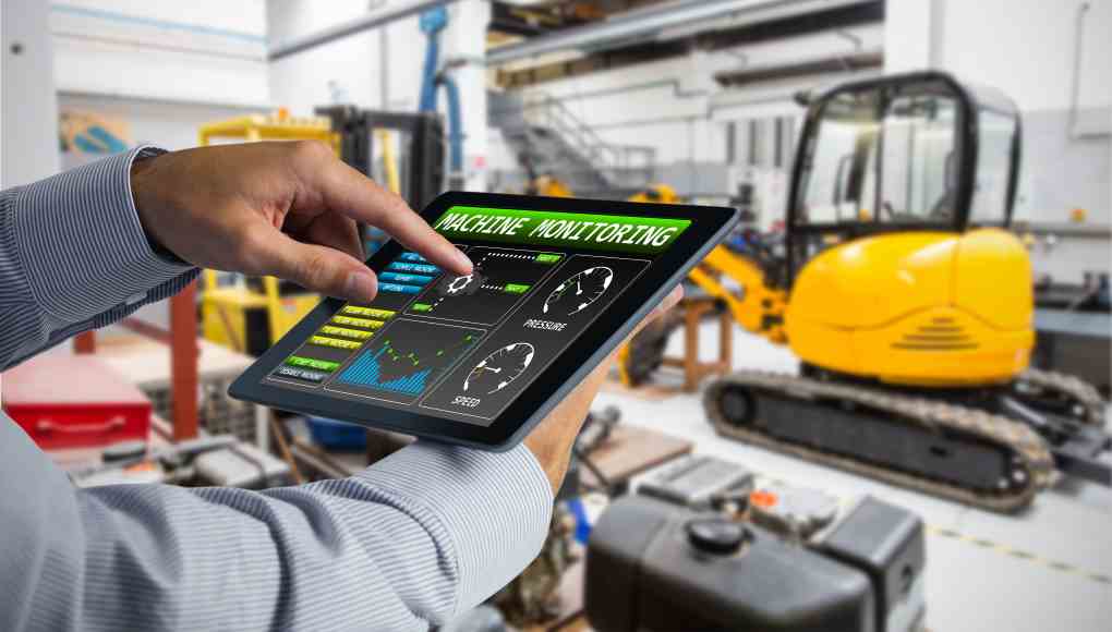 Man using tablet pc  against industrial equipments in factory